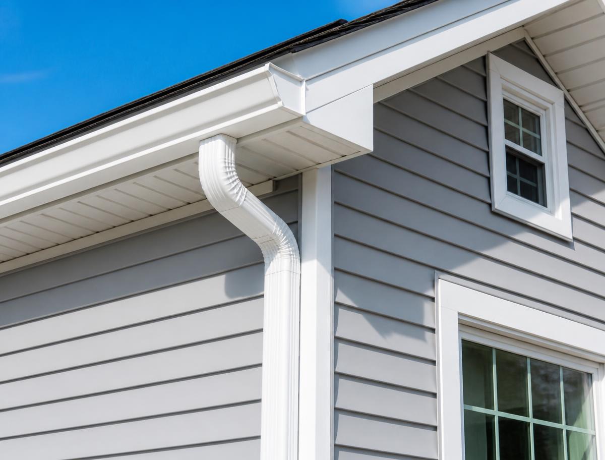 New vinyl siding with seamless white gutters